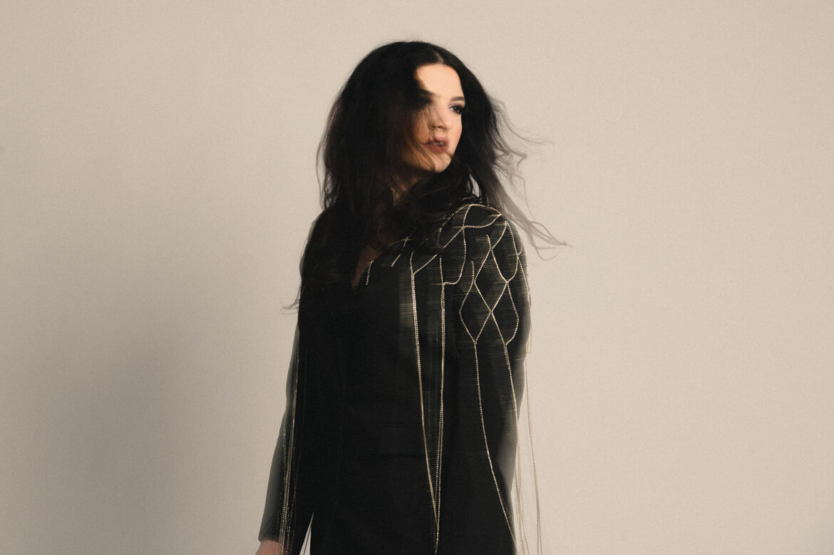 country singer maddi ryan sits against a white wall by boston music photographer lisa czech