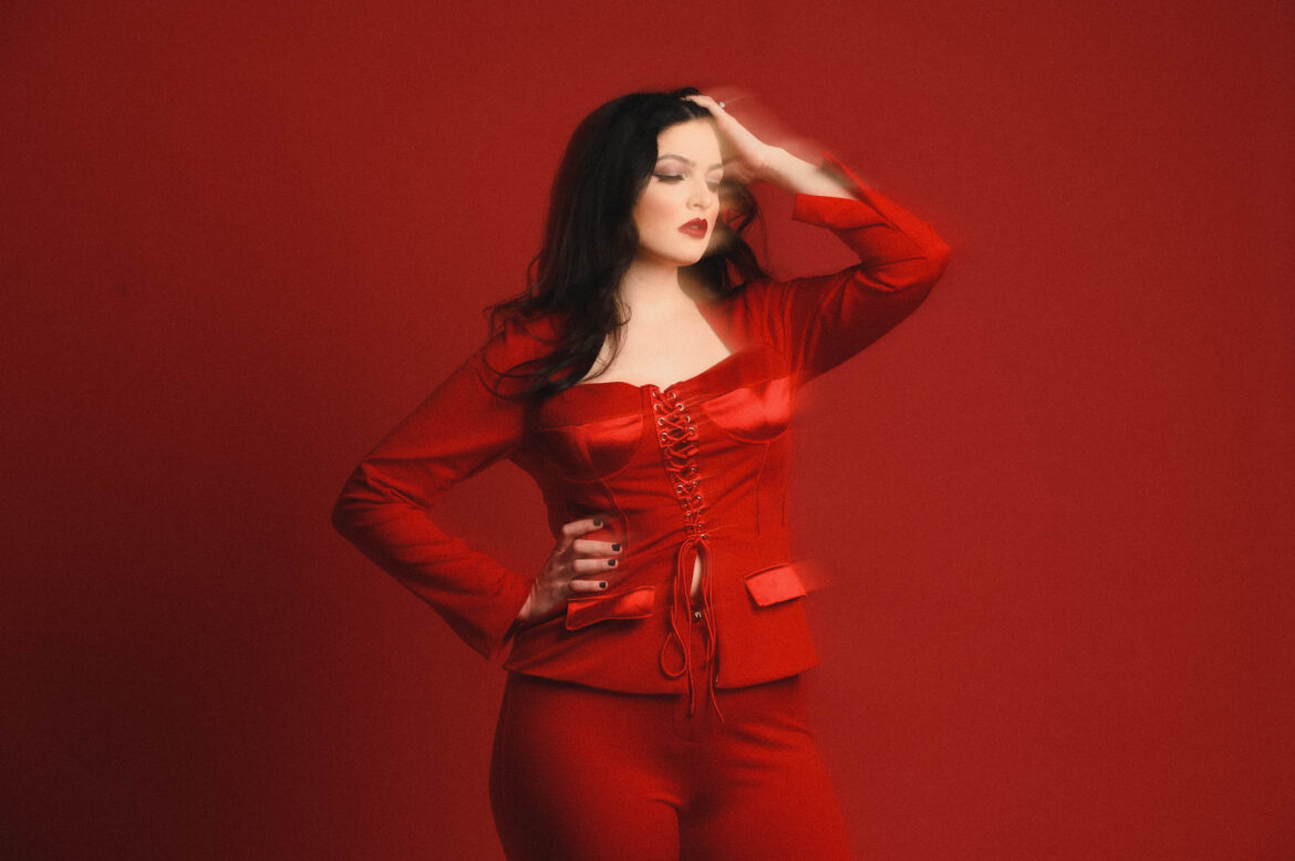 country singer maddi ryan sits against a monochrome red scene by boston music photographer lisa czech